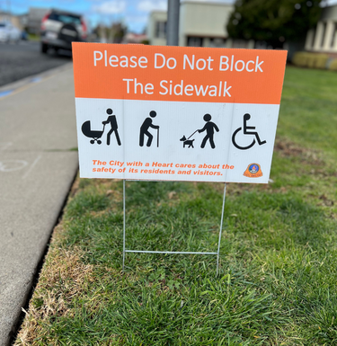 Image of a lawn sign posted at San Bruno City Hall for parking legally